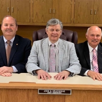 County Commissioners behind desk