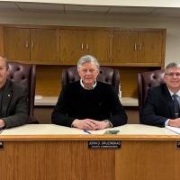 Marshall County Commissioners sitting behind desk