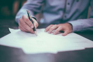 Man writing on paper at a desk