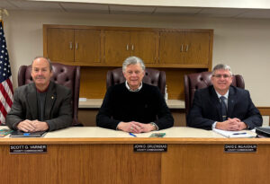 Marshall County Commissioners sitting behind desk