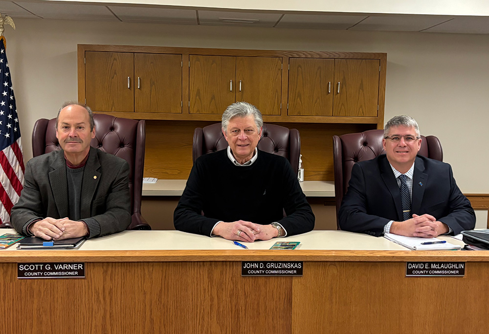 Marshall County Commissioners sitting behind desk